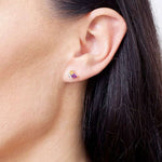 Wielokolorowe kolczyki sztyfty od Venetia Jewels na uchu modelki, idealne do codziennych stylizacji