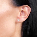 Klasyczne złote kolczyki z brylantami noszone na uchu, idealne do codziennych stylizacji